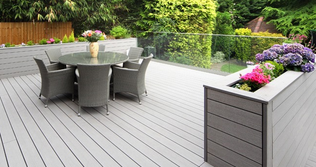 outdoor composite decking with decking planter growing colourful flowers - deck planter ideas