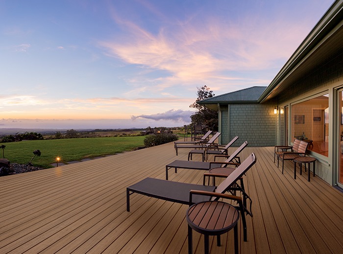 what decking material lasts the longest, easy clean edge oak decking with sunbeds, overlooking beautiful sunset
